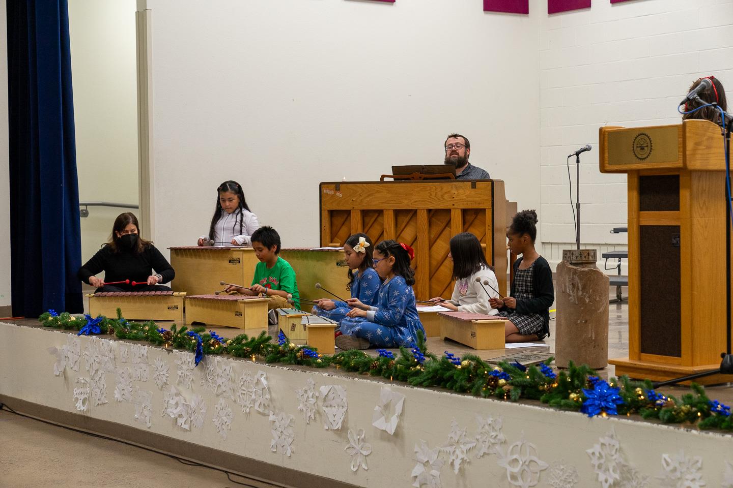 A delightful xylophone ensemble performed alongside their teacher on piano, showcasing student talent and collaboration.